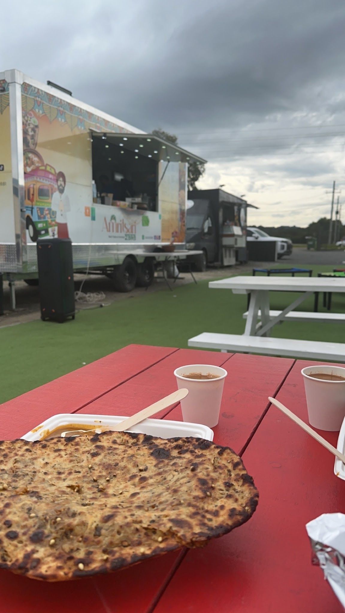 Officer Food Truck Park banner and fire pit lounge area at night